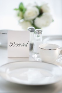 Close up of place setting with reserved sign.