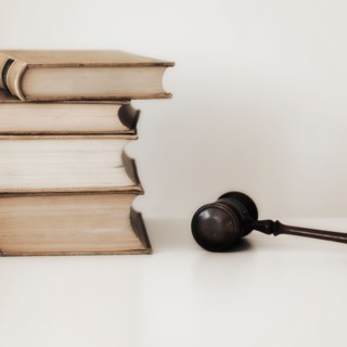 Judges gavel beside stacked law books.