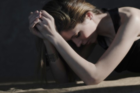 Woman with hands clasped, relaxing.