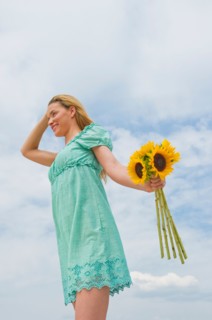 Woman holding sunflowers.