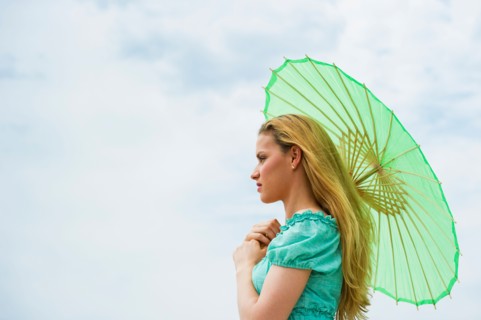 Woman holding parasol.