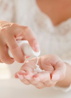 Close up of woman's hands applying moisturizer. Photo: Jamie Grill