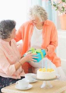 Two senior women celebrating birthday. Photo: Daniel Grill