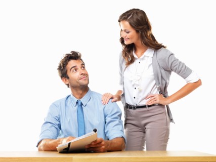 Business woman and business man reading document together. Photo: momentimages