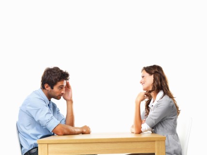 Business couple sitting at table for date. Photo: momentimages