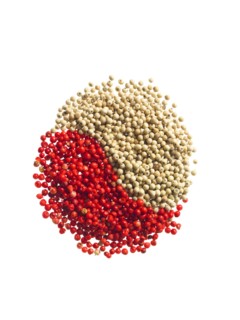 Studio shot of Red Pepper Corns and White Pepper Corns making Yin and Yang sign on white background