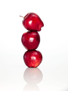 Apples on top of each other on digital tablet, studio shot. Photo : David Arky