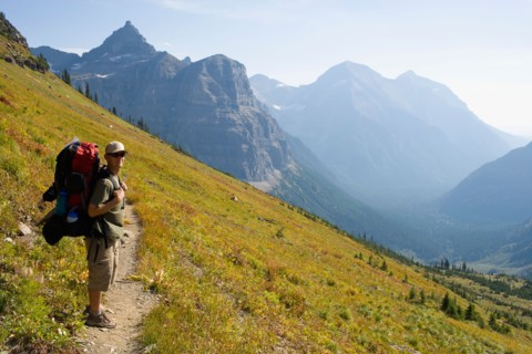 USA, Montana, Glacier National Park, Browns Pass, Mid adult hiker posing . Photo: Noah Clayton