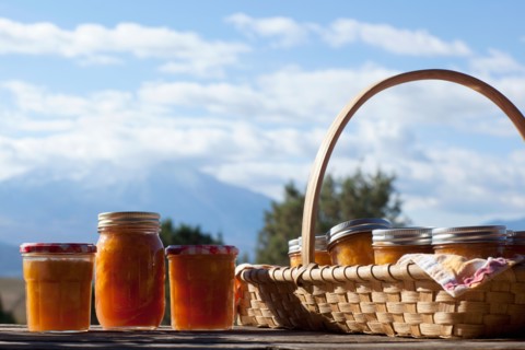 Basket full of jars with preserves. Photo: Noah Clayton