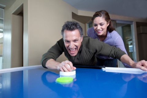 Couple playing air Hockey