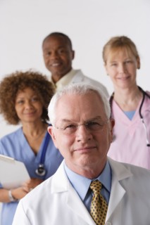 Portrait of four medical professionals, studio shot. Photo : Rob Lewine
