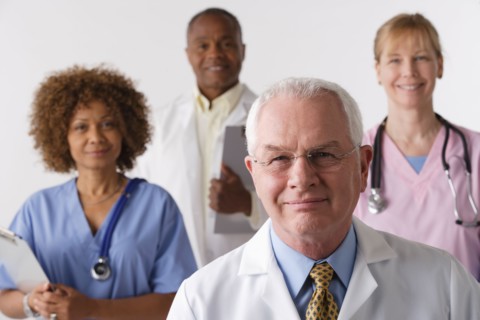 Portrait of four medical professionals, studio shot. Photo : Rob Lewine