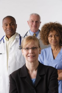 Portrait of four medical professionals, studio shot. Photo : Rob Lewine