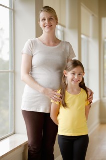 Pregnant woman with daughter (6-7). Photo : Rob Lewine
