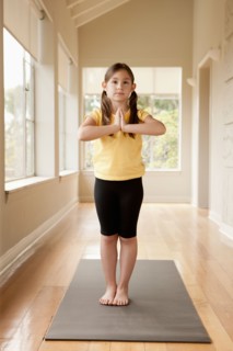 Girl (6-7) practicing yoga. Photo : Rob Lewine