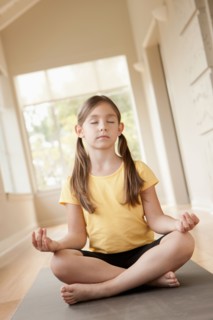 Girl (6-7) practicing yoga. Photo : Rob Lewine