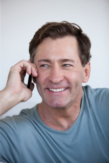 Portrait of mature man with mobile phone. Photo : Rob Lewine