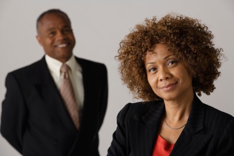 Mature business people, studio shot. Photo: Rob Lewine