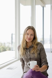 Mature woman relaxing with coffee cup. Photo : Rob Lewine