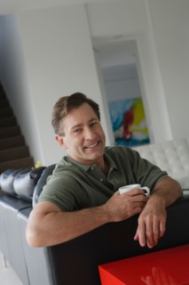 Mature man relaxing on sofa. Photo : Rob Lewine