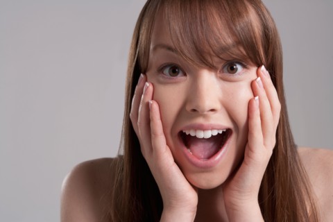 Portrait of young surprised woman, studio shot. Photo : Rob Lewine
