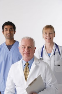 Portrait of three medical professionals, studio shot. Photo : Rob Lewine