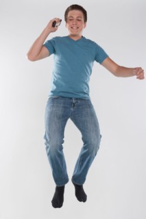 Portrait of teenage boy (16-17) jumping, studio shot. Photo : Rob Lewine