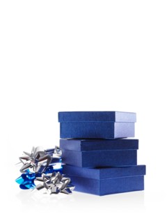 Stack of blue boxes with ribbons, studio shot. Photo : David Arky