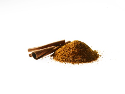 Studio shot of Ground Cinnamon and Cinnamon Sticks on white background. Photo : David Arky