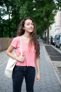 USA, New York, New York City, Portrait of smiling young woman standing on street. Photo : Winslow