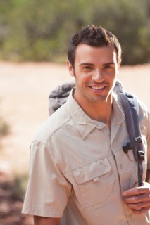 Young man hiking in desert. Photo : db2stock