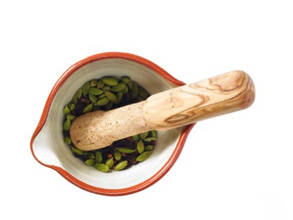 Studio shot of mortar and pestle with cardamom seeds. Photo : David Arky