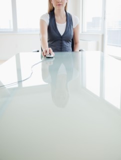 Businesswoman using computer mouse. Photo : Jamie Grill
