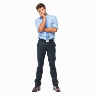 Full length of bored business man standing with hand on face against white background. Photo :