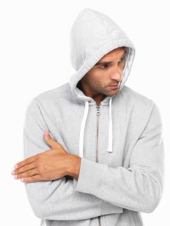 Young man in hoodie looking away. Photo : momentimages