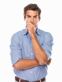 Portrait of business man standing and wondering. Photo : momentimages