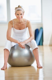Woman sitting on fitness ball.