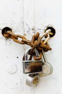 Padlocks and chains on gate.
