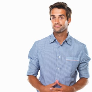 Studio portrait of business man smirking. Photo : momentimages