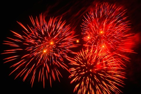 Fireworks explosion against night sky.