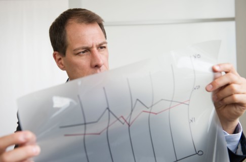 Businessman analyzing graphs.