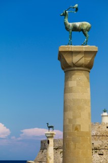 Greece, Rhodes, Mandraki Harbor, Statues on columns.