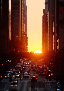USA, New York, New York City, Sunset illuminating busy street.