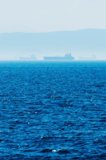 Greece, Oil tankers and cargo ships on Aegean Sea.