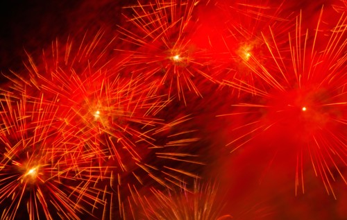 Fireworks explosion against night sky.