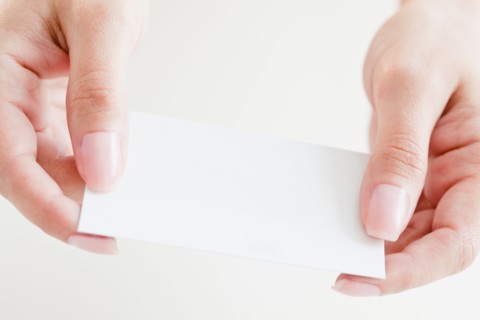 Close up of woman's hands holding credit card. Photo : Jamie Grill