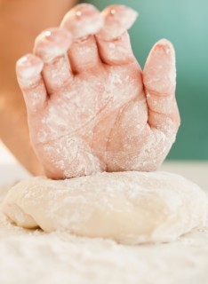 Close up of woman's hand preparing dough. Photo : Jamie Grill