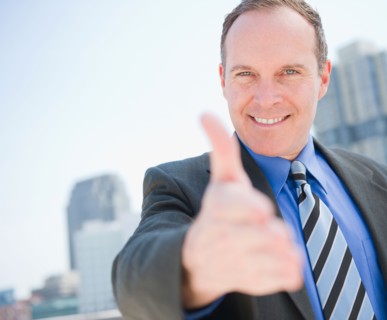 USA, New Jersey, Jersey City, Businessman showing thumbs up. Photo : Jamie Grill