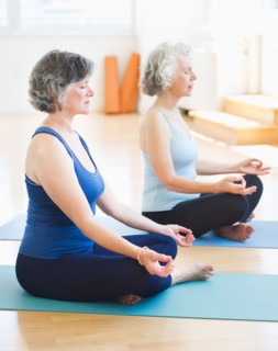 Two senior women practicing yoga. Photo: Daniel Grill