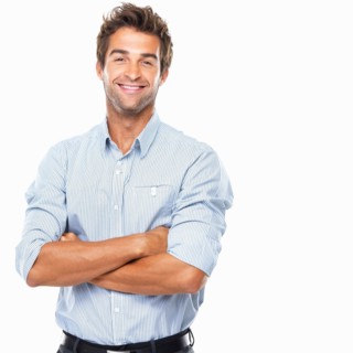 Portrait of smiling business man standing. Photo: momentimages